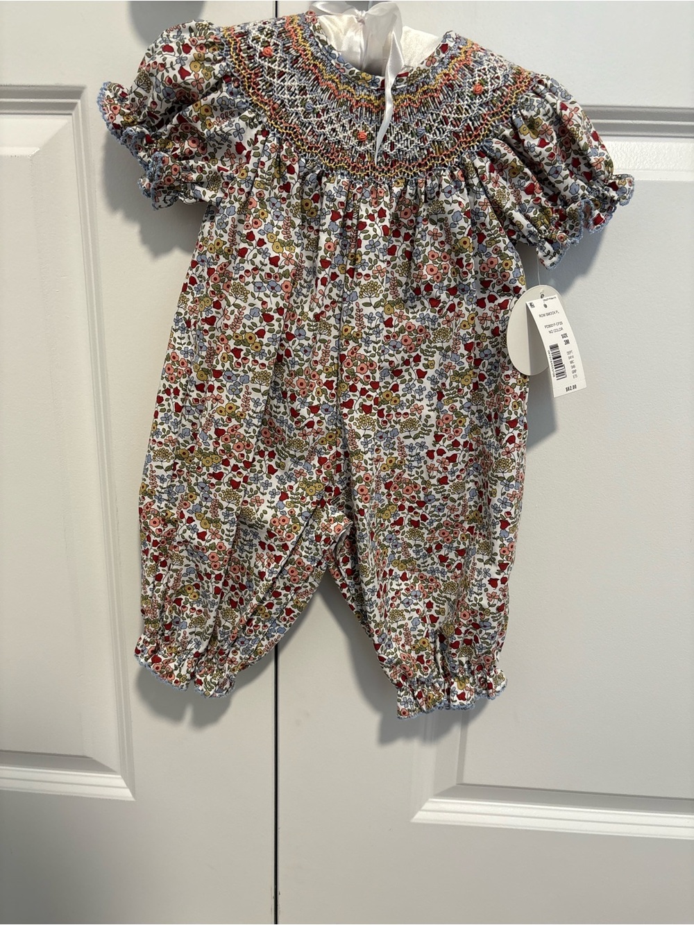 Smocked Floral Baby Romper in White with Red and Green Accents